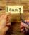 person cutting paper that says "I can't" 